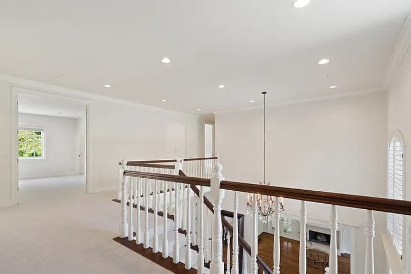 Bienveneda Estate upper landing with turned-baluster railing and chandelier